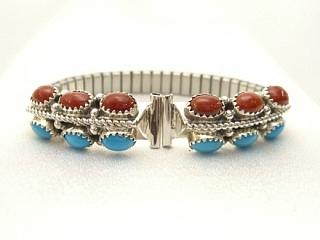 6 Beautiful cabochons of Genuine Turquoise and 6 cabochons of Blood Red Coral set in Sterling Silver. Ladies Watch Tip with expandable band. Created by Navajo Artist Harry Spencer. Signed.