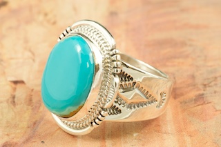 Genuine Manassa Turquoise set in Sterling Silver Ring. This Turquoise is also referred to as King�s Manassa Turquoise. The Manassa Turquoise mine is located in Manassa, Conejos County, Colorado. Created by Navajo Artist John Nelson. Signed by the artist.