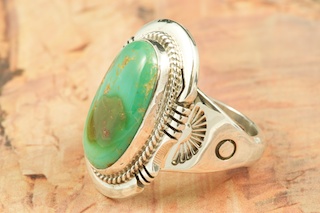 Genuine Manassa Turquoise set in Sterling Silver Ring. This Turquoise is also referred to as King�s Manassa Turquoise. The Manassa Turquoise mine is located in Manassa, Conejos County, Colorado. Created by Navajo Artist John Nelson. Signed by the artist.