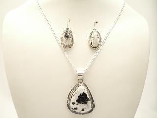 Genuine White Buffalo Turquoise set in Sterling Silver. This Beautiful Stone is formed from the minerals Calcite and Iron. It is mined near Tonopah Nevada. This Beautiful Pendant and Earring Set is a one of a kind Set. The photo is of the jewelry you will be receiving. Created by Navajo Artist Philip Sanchez and Larson Lee. Signed. Free 18 inch Sterling Silver Chain with purchase. 