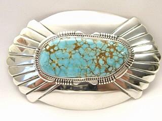 Genuine Number 8 Mine Turquoise Stone set in Heavy Gauge Sterling Silver Belt Buckle. Created by Navajo Artist John Nelson. Signed. The Number 8 mine is located in Eureka County Nevada. Since 1976 there has been no Number 8 Turquoise mined. There is however, an existing stock pile that Mr. Dowell Ward, the last owner of the Number 8 mine, had stocked away for later sorting. The Turquoise is a collector's item--because once the reserve is gone there will be no more material released onto the market. The Gold Mining Company owns the claim to the Number 8 mine and it has been swallowed up by the gold mining operations. This is some of the last Number 8 Turquoise to be had and will be a great addition to your collection. 