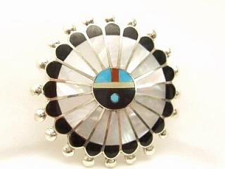 Genuine Mother of Pearl, Black Jade, Turquoise and Coral inlaid between ribons of Sterling Silver. Beautiful Zuni Sunface Brooch. May also be worn as pendant. Signed by the Zuni Artist, N. Chapito Zuni.