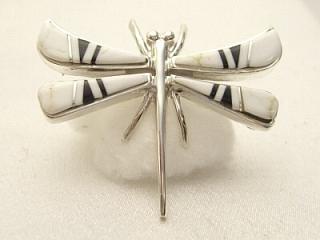 Authentic Native American Jewelry. White Buffalo Turquoise and Jet inlaid between ribbons of Sterling Silver. Stunning Dragonfly Brooch. This Beautiful Stone is formed from the mineral Magnesite. It is mined near Elko Nevada. Created by Navajo Artist Calvin Begay and Olson Charleston. Signed
