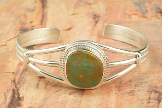 Genuine Crow Springs Turquoise set in Sterling Silver Bracelet. The Crow Springs Mine is located near Tonopah, Nevada. Created by Navajo Artist Margaret Platero. Signed by the artist.
