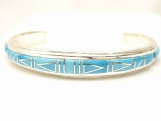 Genuine Turquoise, Sugilite, Spiny Oyster Shell, Abalone Shell and Denim Lapis inlaid in Sterling Silver. Reverseable Bracelet with Beautiful Sterling Silver Design. Designed by Navajo Artist Calvin Begay. 