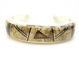 Genuine Picture Jasper, Black Jade and Tigers Eye inlaid between ribbons of Sterling Silver. Stunning Heavy Gauge Sterling Silver Bracelet. Created by Navajo Artist Calvin Begay. Signed.
