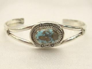 Authentic Native American Jewelry. Genuine Number 8 Mine Turquoise Stone set in heavy gauge Sterling Silver Bracelet. Created by Navajo Artist Mike Ganadonegro.. Signed.  

The Number 8 mine is located in Eureka County Nevada. Since 1976 there has been no Number 8 Turquoise mined. There is however, an existing stock pile that Mr. Dowell Ward, the last owner of the Number 8 mine, had stocked away for later sorting. The Turquoise is a collector's item--because once the reserve is gone there will be no more material released onto the market.
The Gold Mining Company owns the claim to the Number 8 mine and it has been swallowed up by the gold mining operations. This is some of the last Number 8 Turquoise to be had and will be a great addition to your collection.
