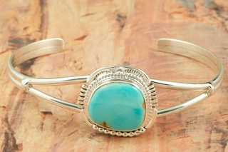 Genuine Manassa Turquoise set in Sterling Silver Bracelet. This Turquoise is also referred to as King�s Manassa Turquoise. The Manassa Turquoise mine is located in Manassa, Conejos County, Colorado. Created by Navajo Artist John Nelson. Signed.