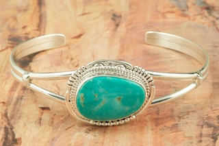 Genuine Manassa Turquoise set in Sterling Silver Bracelet. This Turquoise is also referred to as King�s Manassa Turquoise. The Manassa Turquoise mine is located in Manassa, Conejos County, Colorado. Created by Navajo Artist John Nelson. Signed.