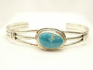 Genuine Turquoise Mountain Mine Turquoise set in Sterling Silver Bracelet. The Turquoise Mountain Mine is located in the Mineral Park Mining District, Mohave County, Arizona. Although Turquoise Mountain is located near the Kingman Turquoise Mine it is considered a classic mine in its own right because the Turquoise is so different in appearance. It is also known as 