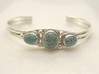 Authentic Native American Jewelry. Genuine Number 8 Mine Turquoise Stones set in heavy gauge Sterling Silver Bracelet. Created by Navajo Artist Milton Lee. Signed.  The Number 8 mine is located in Eureka County Nevada. Since 1976 there has been no Number 8 Turquoise mined. There is however, an existing stock pile that Mr. Dowell Ward, the last owner of the Number 8 mine, had stocked away for later sorting. The Turquoise is a collector's item--because once the reserve is gone there will be no more material released onto the market. The Gold Mining Company owns the claim to the Number 8 mine and it has been swallowed up by the gold mining operations. This is some of the last Number 8 Turquoise to be had and will be a great addition to your collection. 