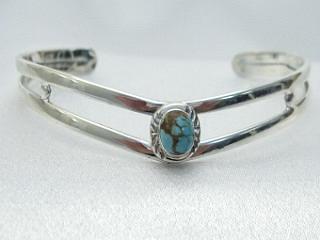 Genuine Number 8 Mine Turquoise set in Sterling Silver Bracelet. The Number 8 mine is located in Eureka County Nevada. Since 1976 there has been no Number 8 Turquoise mined. There is however, an existing stock pile that Mr. Dowell Ward, the last owner of the Number 8 mine, had stocked away for later sorting. The Turquoise is a collector's item--because once the reserve is gone there will be no more material released onto the market. The Gold Mining Company owns the claim to the Number 8 mine and it has been swallowed up by the gold mining operations. This is some of the last Number 8 Turquoise to be had and will be a great addition to your collection.  Created by Navajo Artist  Freddy Charley. Signed FC.