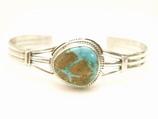 Genuine Pilot Mountain Turquoise set in Sterling Silver Bracelet. The Pilot Mountain Mine is located in Esmeralda County, Nevada. Created by Navajo Artist Kathy Yazzie. Signed.