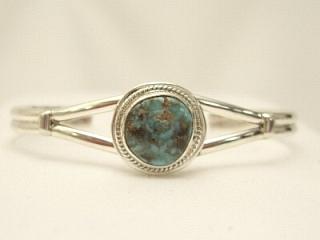 Genuine Royston Turquoise set in Sterling Silver Bracelet. The Royston Turquoise Mine was originally known as the Royal Blue Mine. It produces Turquoise that has a mixture of blues and greens in the same formation. The Royston Turquoise Mine is located in Nye County, Nevada. Created by Navajo Artist Thomas Valencia. Signed.