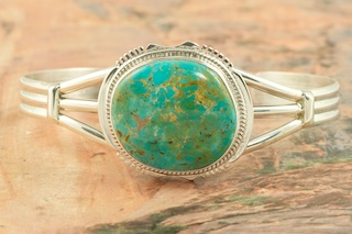 Genuine Manassa Turquoise set in Sterling Silver Bracelet. This Turquoise is also referred to as King�s Manassa Turquoise. The Manassa Turquoise mine is located in Manassa, Conejos County, Colorado. Created by Navajo Artist John Nelson. Signed by the artist.
