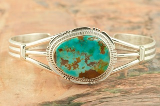 Genuine Manassa Turquoise set in Sterling Silver Bracelet. This Turquoise is also referred to as King�s Manassa Turquoise. The Manassa Turquoise mine is located in Manassa, Conejos County, Colorado. Created by Navajo Artist John Nelson. Signed by the artist. 