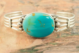 Genuine Manassa Turquoise set in Sterling Silver Bracelet. This Turquoise is also referred to as King�s Manassa Turquoise. The Manassa Turquoise mine is located in Manassa, Conejos County, Colorado. Created by Navajo Artist Lucy Valencia. Signed L. J. by the artist.
