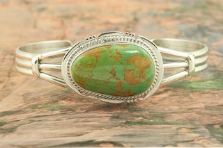 Genuine Manassa Turquoise set in Sterling Silver Bracelet. This Turquoise is also referred to as King�s Manassa Turquoise. The Manassa Turquoise mine is located in Manassa, Conejos County, Colorado. Created by Navajo Artist John Nelson. Signed by the artist.