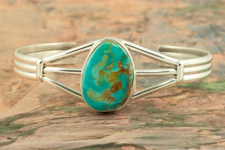 Genuine Manassa Turquoise set in Sterling Silver Bracelet. This Turquoise is also referred to as King�s Manassa Turquoise. The Manassa Turquoise mine is located in Manassa, Conejos County, Colorado. Created by Navajo Artist Lucy Valencia. Signed L. J. by the artist.