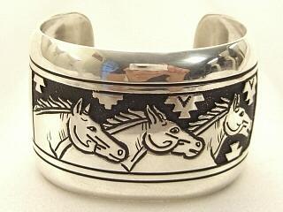 Sterling Silver Bracelet with beautiful wild horses overlay Design. Heavy gauge Sterling Silver. Created by Navajo Artist Tommy Singer. Signed.