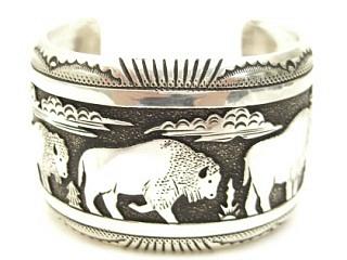 Stunning heavy gauge Sterling Silver Bracelet with Buffalo Designs. Beautiful overlay technique. Created by Navajo Artist Tommy Singer. Signed
