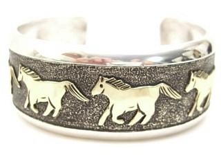 Sterling Silver Bracelet with Wild Horses Design. Beautiful overlay technique with 12K Gold. Created by Navajo Artist Tommy Singer. Signed Thomas Singer.