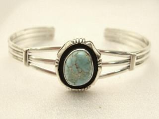 Genuine Dry Creek Turquoise set in Sterling Silver Bracelet. The Dry Creek Mine is located near Battle Mountain, Nevada. Dry Creek Turquoise forms when there are no heavy metals present such as copper or iron. To date, no other vein of this Turquoise has been discovered anywhere else other than the Dry Creek Mine and when this vein runs out, that will be the last of it. Because this Turquoise is as rare as the sacred buffalo, the Indians call it "Sacred Buffalo Turquoise". Created by Navajo Artist E. Delgarito.