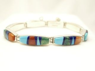 Genuine Sleeping Beauty Turquoise, Spiny Oyster Shell and Black Jade inlaid between ribbons of Sterling Silver. Stunning Bracelet with precision channel inlay. Designed by Navajo Artist Calvin Begay. Signed.