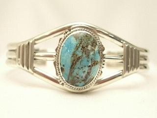 Genuine Royston Turquoise set in Sterling Silver Bracelet. The Royston Turquoise Mine was originally known as the Royal Blue Mine. It produces Turquoise that has a mixture of blues and greens in the same formation. The Royston Turquoise Mine is located in Nye County, Nevada. Created by Navajo Artist Larson Lee.