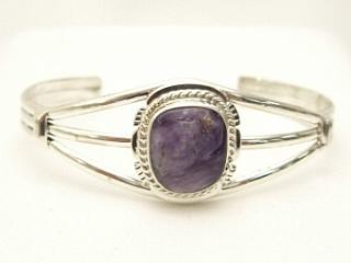 Genuine Charoite set in heavy gauge Sterling Silver Bracelet. Created by Navajo Artist Margaret Platero. Charoite is a Beautiful and interesting gemstone first introduced in the US around 1976. It's vivid colors range from lavender to deep chatoyant purple. It is mined in Siberia Russia near Charo River, Lake Baikal region. High grade charoite is distinguished by mixtures of deep rich purple and silky zones, in swirly and/or needle-like chatoyant patterns/sprays. 
