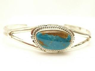 Genuine Blue Gem Turquoise set in Sterling Silver Bracelet. The Blue Gem Turquoise Mine which is no longer active produced almost every shade of green and blue turquoise. The Blue Gem Mine was located in Nevada near Battle Mountain. Created by Navajo Artist John Nelson. Signed.