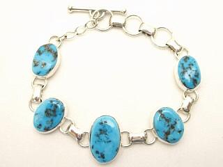 5 Sleeping Beauty Turquoise Stones set in Sterling Silver Link Bracelet. The Sleeping Beauty Turquoise mine is located in Gila County, Arizona. This Beautiful Bracelet is a one of a kind Bracelet. The photo is of the jewelry you will be receiving. Created by Navajo Artist Tony Garcia. Signed.
