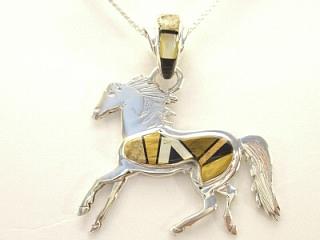 Genuine Tiger Eye, Picture Jasper, Spiny Oyster Shell and Black Jade inlaid between ribbons of Sterling Silver. Beautiful inlay work on the bale. Horse Pendant features Mother of Pearl accents. Designed by Navajo Artist Calvin Begay. Signed.