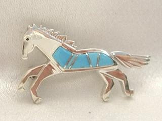 Genuine Turquoise inlaid between Ribbons of Sterling Silver. Galloping Horse Created by Navajo Artist Calvin Begay.