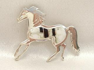 Genuine White Buffalo Turquoise and Black Jade inlaid between ribbons of Sterling Silver. Horse Brooch Created by Navajo Artist Calvin Begay.
