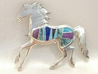 Genuine Turquoise, Blue Lapis and Suglite inlaid between ribbons of Sterling Silver. Horse Brooch Created by Navajo Artist Calvin Begay and Virginia Smith.