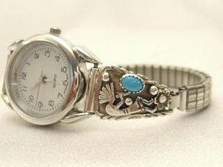Genuine Turquoise set in Sterling Silver Watch Tips. Sterling Silver Kokopelli Design. Ladies quartz watch with expandable watch band. Created by Navajo Artist Tony Garcia.