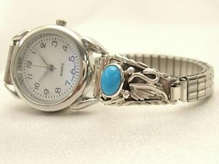 Genuine Sleeping Beauty Turquoise set in Sterling Silver Watch Tips. Sterling Silver Leaf Design. Ladies quartz watch with expandable watch band. The Sleeping Beauty Turquoise mine is located in Gila County, Arizona. Navajo Made.