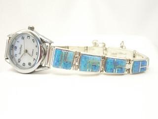 Stunning Watch Bracelet with Fire and Ice Lab Opals inlaid between ribbons of Sterling Silver. Designed by Navajo Artist Calvin Begay. Signed.
