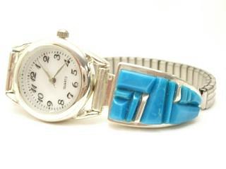 Genuine Sleeping Beauty Turquoise set in Sterling Silver. Beautiful handcarved Turquoise Stones set between ribbons of Sterling Silver. Stunning Ladies Watch. Created by Navajo Artist Calvin Begay. Signed.
