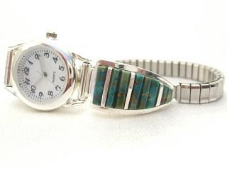 Beautiful Hand Carved Nevada Turquoise inlaid between ribbons of Sterling Silver. Ladies Watch with expandable watch band. Designed by Navajo Artist Calvin Begay. Signed.