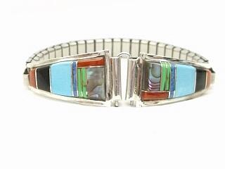 Genuine Abalone Shell, Turquoise, Coral, and Black Jade inlaid between ribbons of Sterling Silver. Ladies Watch Tips with expandable band. Created by Zuni Artist Chester Shodene Lonjose. Signed. 