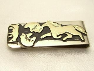 Authentic Native American Jewelry. Beautiful Gold fill Animal Designs on oxidized Sterling Silver set on a Nickel Silver Money Clip. Featuring a Horse, Bear, Deer and Buffalo. Created by Navajo Artist Tommy Singer. 
