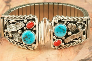 Genuine Sleeping Beauty Turquoise and Coral set in Sterling Silver. Beautiful Sterling Silver Eagle Design. Mens Watch Tips with expandable band. Created by Navajo Artist Thomas Chischilly.