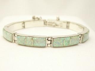 Beautiful Fire & Ice Lab Opals inlaid between ribbons of Sterling Silver. Beautiful channel inlay design. Designed by Navajo Artist Calvin Begay. Signed. 
