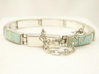 Authentic Native American Jewelry. Beautiful Fire & Ice Lab Opals inlaid between ribbons of Sterling Silver. Beautiful channel inlay design. Created by Navajo Artist Calvin Begay. Signed. 
