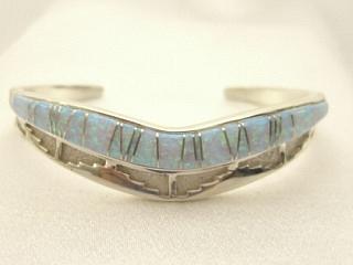 Beautiful Fire & Ice Lab Opals inlaid between ribbons of Sterling Silver. Stunning Aztec Design in this Heavy Gauge Sterling Silver Bracelet. Designed by Navajo Artist Calvin Begay. Signed.