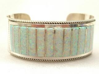 Authentic Native American Jewelry. Beautiful Fire & Ice Lab Opals inlaid between ribbons of Sterling Silver. Opal bracelet created by Zuni Artist Emery Lalacita. Signed 