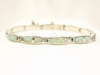 Beautiful Fire & Ice Lab Opals inlaid between ribbons of Sterling Silver. Stunning Opal Bracelet Designed by Navajo Artist Calvin Begay. Signed. 