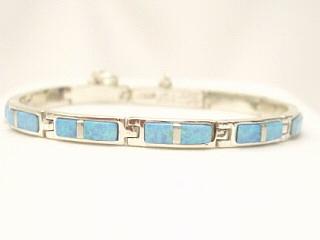 Beautiful Fire & Ice Lab Opals inlaid between ribbons of Sterling Silver. Beautiful precision inlay design. Opal Bracelet created by Navajo Artist Calvin Begay. Signed 
